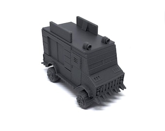 May include: A dark gray toy truck with a detailed design. The truck has a boxy shape, small wheels, and features like a front grill, side panels, and a roof with two raised sections. The overall aesthetic suggests a military or industrial theme.