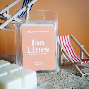 May include: A clear plastic package containing a peach-colored wax melt with the text "Chill, Babe Candle Co" and "Tan Lines" in white. The text below reads "Sunblock Beach/Pool Days" and "2.75 oz / 178 grams Soy Wax Melt".
