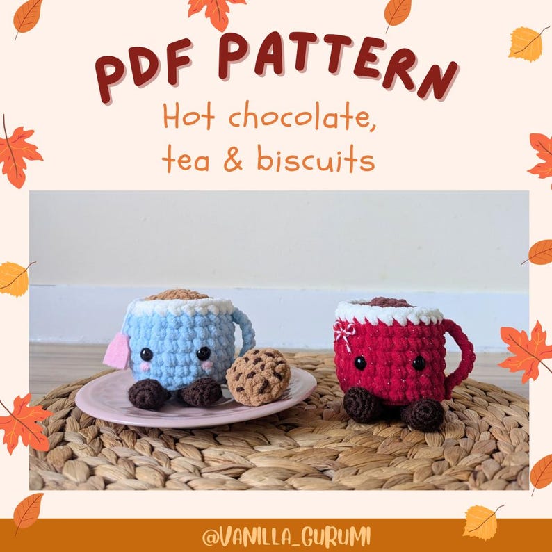 May include: Two crocheted amigurumi teacups, one blue and one red, with smiling faces and chocolate chip cookies on a pink saucer. The teacups are sitting on a woven wicker surface. The text "PDF PATTERN Hot chocolate, tea & biscuits" is at the top of the image.