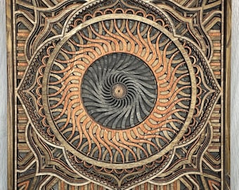 May include: Square wooden wall art featuring a layered design with a central spiral and radiating sun-like elements. The artwork uses shades of brown, orange, and gray, creating a three-dimensional effect. The piece is framed in a dark wood.