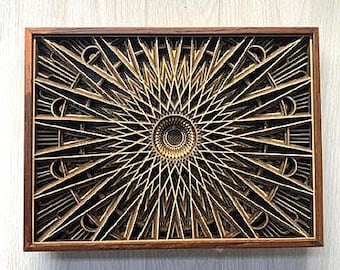 May include: A layered wooden art piece with a geometric sunburst design. The artwork features a dark brown frame and intricate layers of light brown and black wood, creating a three-dimensional effect. The central focus is a circular pattern.
