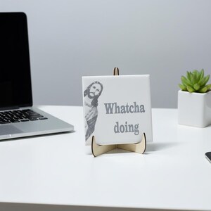 Funny Jesus Tile | Ceramic Jesus Saying Tile with "Whatcha Doing" | Religious Humor Gift | Catholic Christian Home Decor | Divine Comedy shown in an AI-generated listing photo