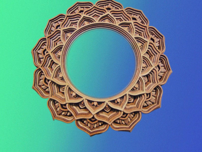 A front-facing view of a round wooden mandala wall mirror featuring stacked concentric petal layers over a blue and green gradient background.