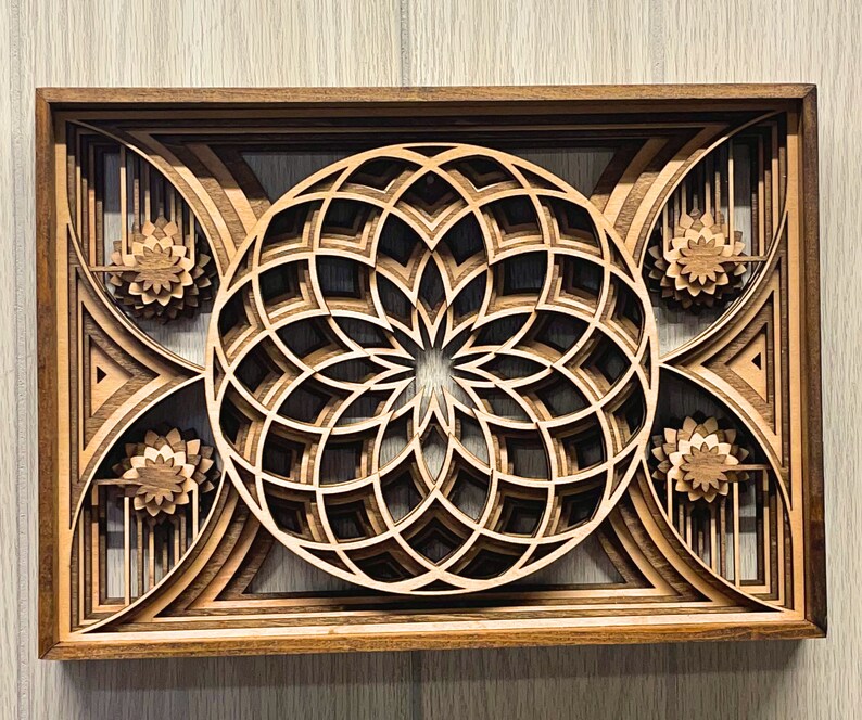 Add a touch of spiritual harmony to your living space with this stunning sacred geometry Mandala. This framed mandala features the mesmerizing Flower of Life design at its center, surrounded by radiating geometric patterns inspired by the Torus.