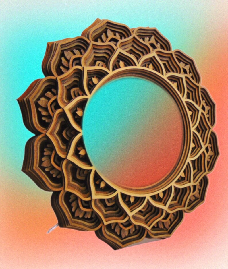 A layered wooden mandala mirror angled against a colorful gradient background of teal and orange.