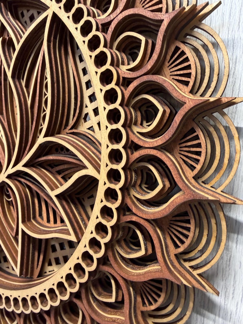 A close-up, angled view of a layered wooden lotus mandala, showing the intricate details and varying wood tones of the petals and outer rings.