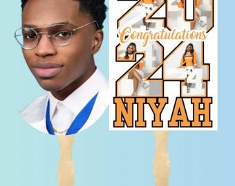 May include: A set of two graduation fans with a photo of a young man on one fan and a design with the numbers 2024 and the word "Congratulations" on the other fan. The design also includes photos of four people in graduation caps and gowns. The fans are labeled "Fans" at the bottom.