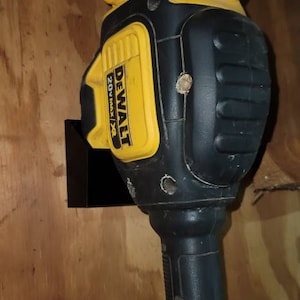 May include: A black and yellow DeWalt 20V Max XR cordless string trimmer with a black wall mount. The trimmer has a black handle and a yellow trigger.