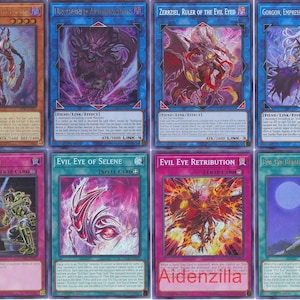 May include: A set of ten trading cards featuring characters and spells from the "Evil Eye" series. The cards are in a blue, pink, and purple color scheme with images of monsters and magic.