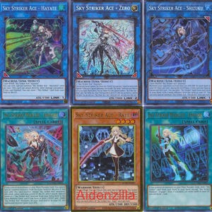 May include: A collection of Yu-Gi-Oh! trading cards featuring the "Sky Striker Ace" series. The cards display various characters in dynamic poses with vibrant colors, including red, green, blue, and gold. The text "SKY STRIKER ACE" is visible on several cards.
