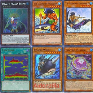 May include: A set of ten trading cards featuring illustrations of various sea creatures, including a kraken, a whale, a jellyfish, and a fisherman. The cards are all in the same style, with a blue background and white borders. The text on the cards is in English.
