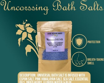 May include: A brown paper bag with a blue bath salt product inside. The bag has a label that says "Uncrossin Bath Salts" and "Divine Healing Hands". The label also includes instructions for use. The bag is sitting on a green background with a shield and a nose icon.
