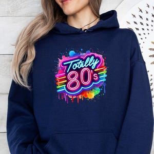May include: A navy blue hoodie with a colorful graphic of the text "Totally 80's" in a neon style with dripping paint.