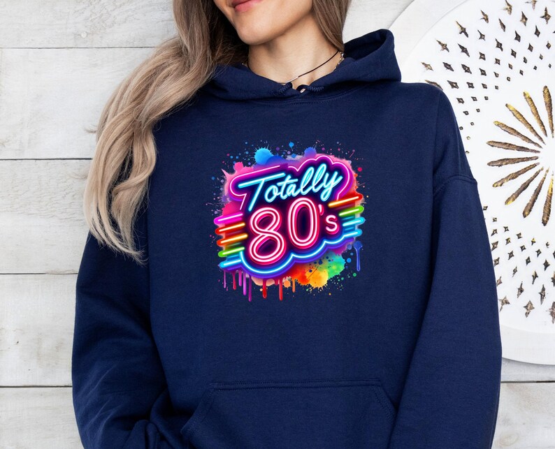 May include: A navy blue hoodie with a colorful graphic of the text "Totally 80's" in a neon style with dripping paint.