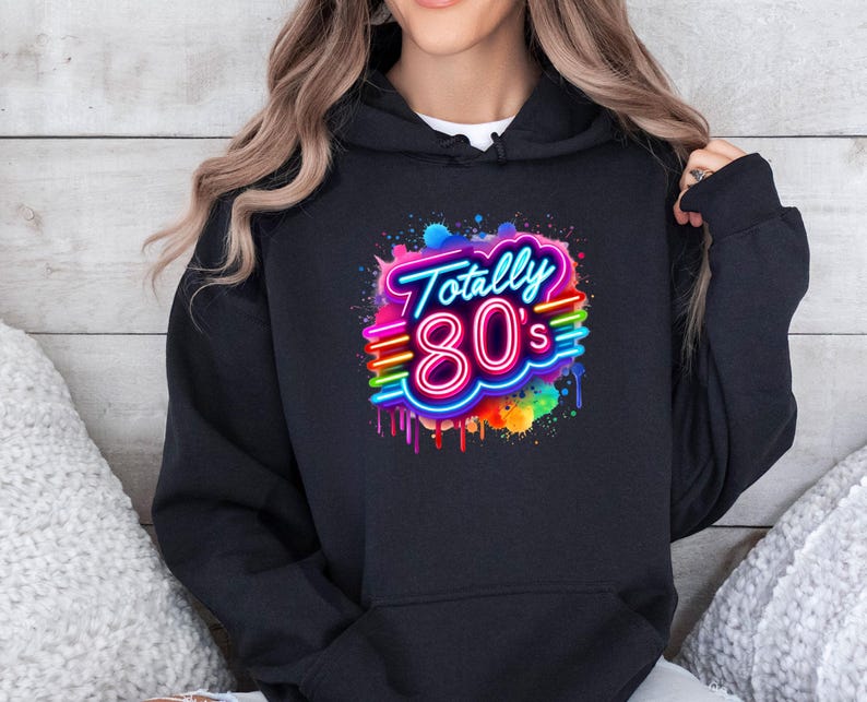 May include: Black hoodie with a colorful graphic print of the text "Totally 80's" in a neon style with rainbow accents.