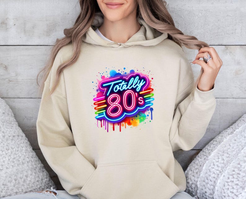 May include: A beige hoodie with a colorful graphic print that says "Totally 80's" in a neon style.