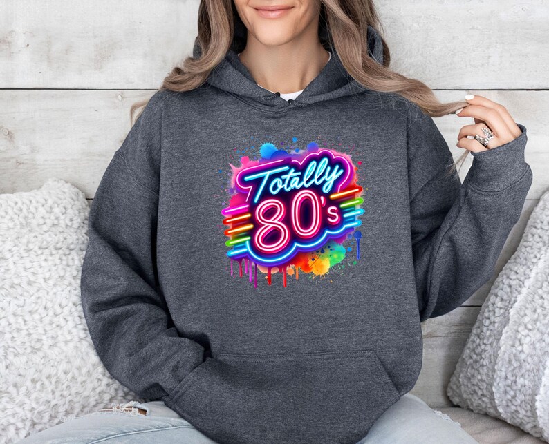 May include: A dark gray hoodie with a neon pink and blue graphic that says "Totally 80's" with a rainbow paint splatter effect.