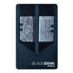 May include: A black plastic card holder with two slots for razor blades. The card holder has the text "BLADEBANK. exceed Designs" printed on the bottom.