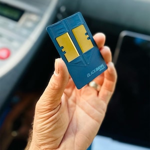 May include: A blue card with the text "BLADEBANK" printed on it. The card has two gold-colored slots.