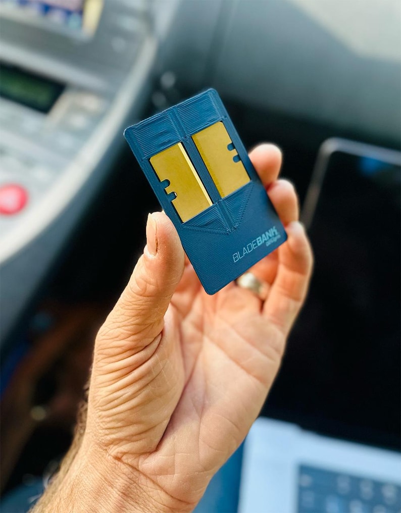 May include: A blue card with the text "BLADEBANK" printed on it. The card has two gold-colored slots.