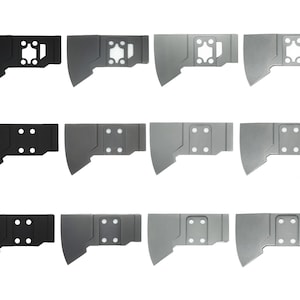 May include: Twelve axe heads in various finishes, including black, grey, and silver. The axe heads have a unique design with a hole in the centre and a rectangular shape.