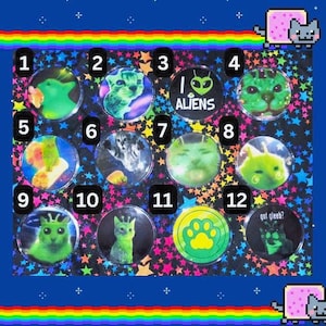May include: A sheet of stickers with various designs, including cat-like aliens, a paw print, and the text "I Aliens" and "got gleeb?". The stickers are set against a colorful background with a rainbow border and pixelated cat graphics.