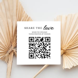 May include: A square white card with the text "SHARE THE love" and "SCAN TO UPLOAD YOUR PHOTOS & VIDEOS" in black. A black and white QR code is below the text. The card is set against a backdrop of dried, beige palm leaves.