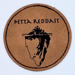 May include: A brown leather coaster with the text "PETTA REDDAST" and a black silhouette of an iceberg.