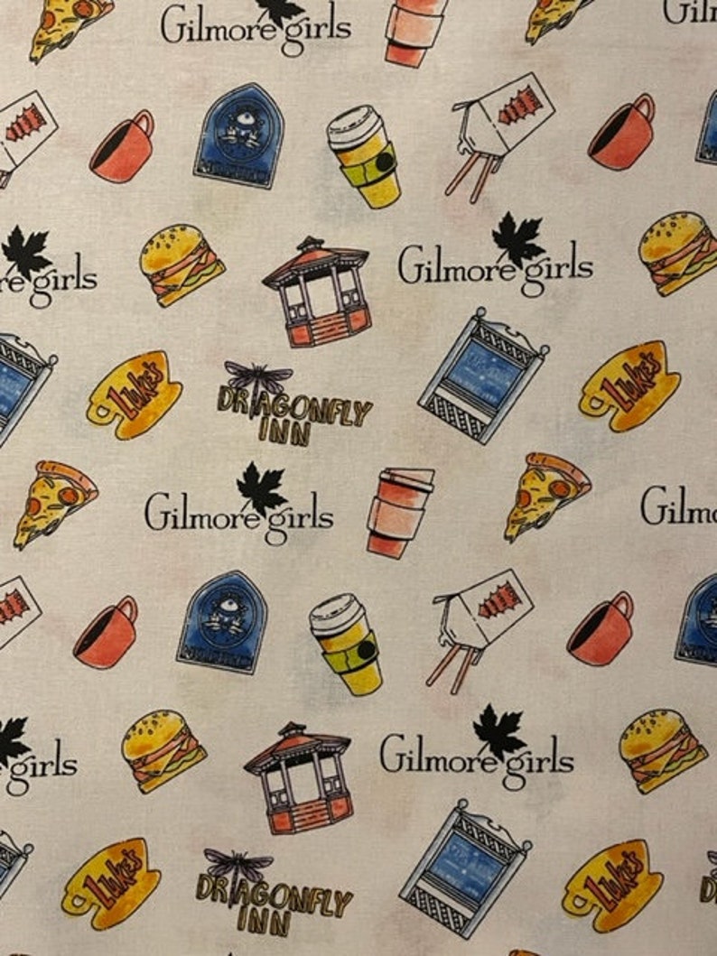 May include: A white fabric with a repeating pattern of illustrations and text. The illustrations include a coffee cup, pizza slice, burger, gazebo, and a blue sign. The text includes "Gilmore girls", "Luke's", and "Dragonfly Inn".