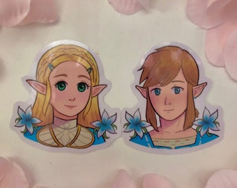 May include: Two cartoon stickers featuring characters from the Legend of Zelda video game series. The stickers are on a white background with pink flower petals surrounding them. The first sticker features a female character with blonde hair, blue eyes, and a blue and gold outfit. The second sticker features a male character with brown hair, blue eyes, and a blue and brown outfit. Both characters have pointed ears and are surrounded by blue flowers.