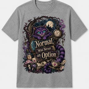 May include: A heather gray short-sleeve t-shirt featuring a graphic print of a purple striped cat, a pocket watch, mushrooms, and playing cards. The text "Normal Was Never an Option" is centered in the design with dark, whimsical forest elements.