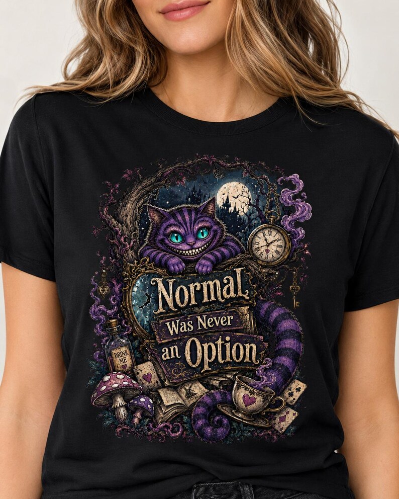 May include: A black short-sleeved t-shirt featuring a graphic print of a purple striped cat with glowing teal eyes. The design includes a pocket watch, a bottle labeled Drink Me, mushrooms, and the text Normal Was Never an Option.