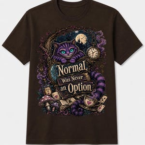 May include: A dark brown t-shirt featuring a graphic print of a purple striped cat with a wide grin, a pocket watch, mushrooms, a 'Drink Me' bottle, playing cards, and a teacup. The text 'Normal Was Never an Option' is centered in the design.