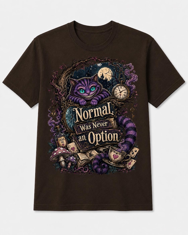 May include: A dark brown t-shirt featuring a graphic print of a purple striped cat with a wide grin, a pocket watch, mushrooms, a 'Drink Me' bottle, playing cards, and a teacup. The text 'Normal Was Never an Option' is centered in the design.