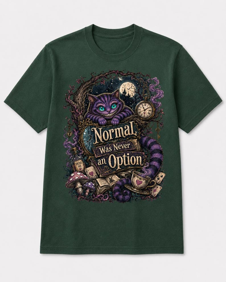 May include: A dark green short-sleeve t-shirt featuring a graphic print of a purple striped cat, a pocket watch, mushrooms, playing cards, and a bottle labeled Drink Me. The text reads Normal Was Never an Option in a decorative font style.