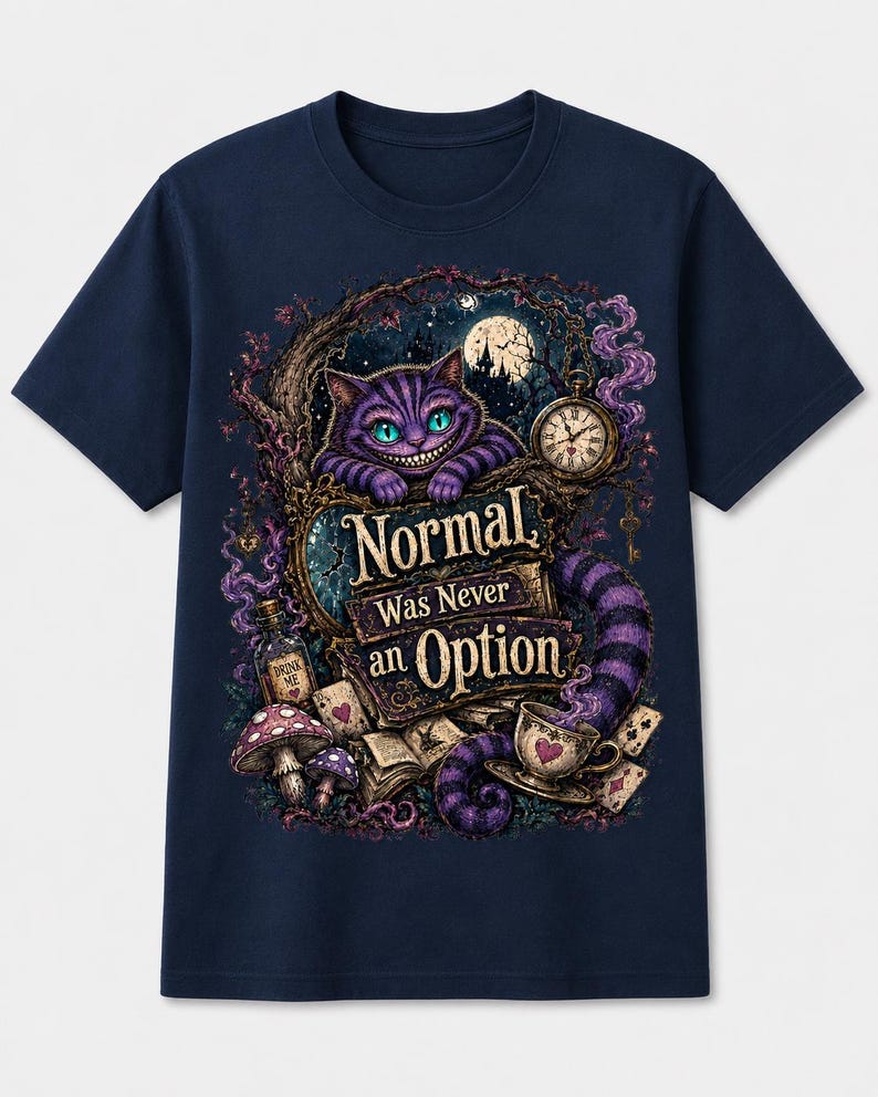 May include: A navy blue t-shirt featuring a graphic print of a purple striped cat with glowing eyes, a pocket watch, mushrooms, playing cards, and a bottle labeled Drink Me. The text reads Normal Was Never an Option in a decorative font.