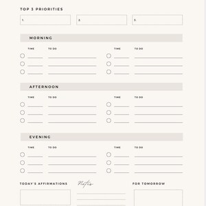 May include: A printable daily planner with sections for top 3 priorities, morning, afternoon, evening, today's affirmations, notes, and for tomorrow. The planner has a simple design with a light gray background and black text.
