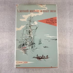 May include: Vintage book cover titled "Vancouver's Discovery of Puget Sound" with a nautical illustration. The cover features a large sailing ship, smaller boats, and text in a retro style. The book is by Edmond S. Meany.
