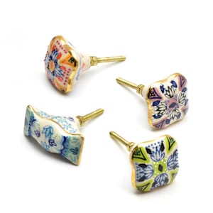May include: Set of four ceramic cabinet knobs with intricate floral patterns in shades of blue, green, pink, and orange. Each knob has a gold-toned metal base and a screw for installation.