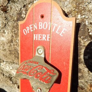 Coca-Cola Starr X Brown Co News VA metal bottle opener with wall holder.
