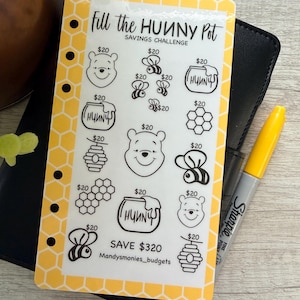 May include: A rectangular savings challenge tracker with a yellow honeycomb border. The card features black line art icons including bears, bees, honey pots, and honeycombs, each labeled $20. Text reads Fill the HUNNY Pot, SAVE $320, and Mandysmonies_budgets.
