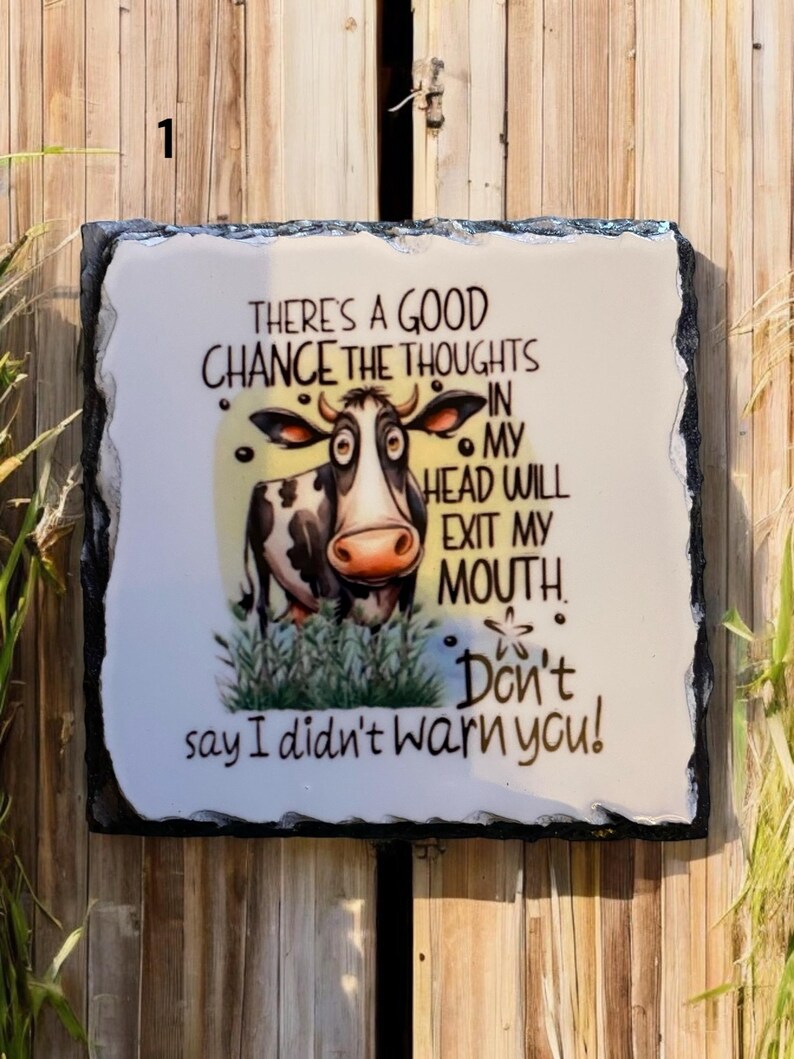 May include: A rectangular decorative slate sign with a white background and a black border. The sign features a cartoon cow and the text "THERE'S A GOOD CHANCE THE THOUGHTS IN MY HEAD WILL EXIT MY MOUTH. Don't say I didn't warn you!"
