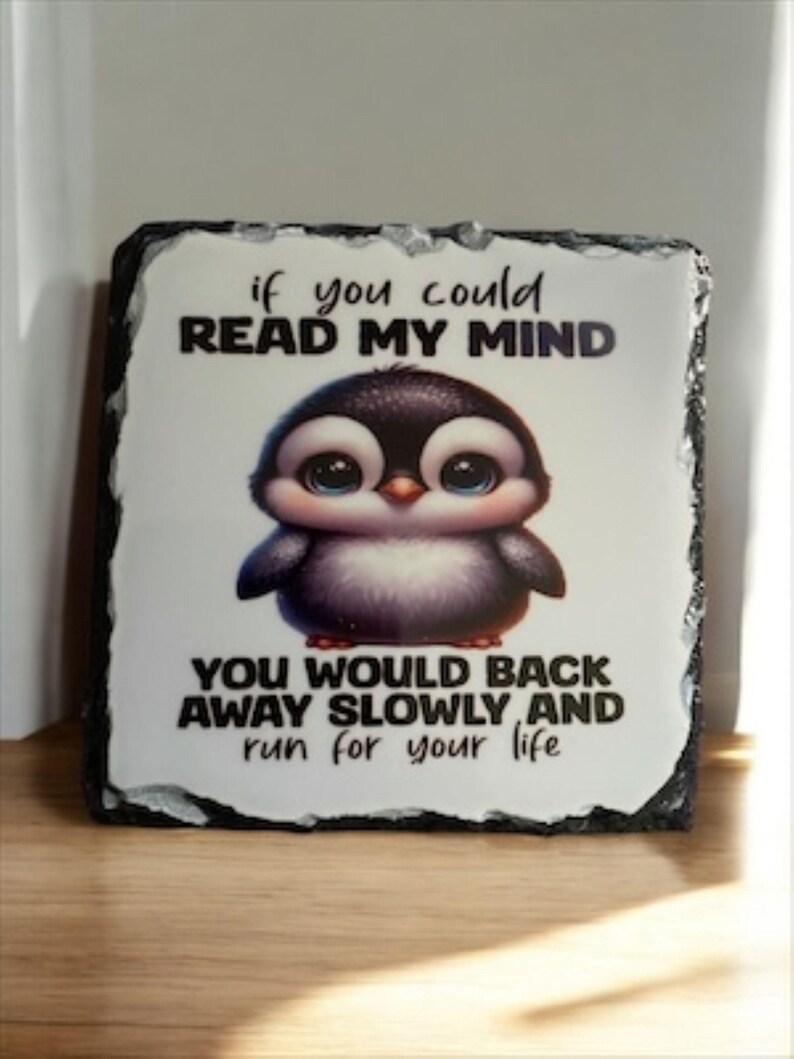 May include: A decorative slate sign featuring a cartoon penguin with large blue eyes. The sign has the text "if you could read my mind, you would back away slowly and run for your life."