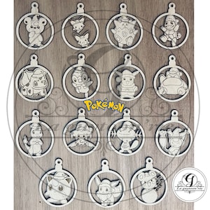 May include: Wooden Christmas ornaments featuring various Pokémon characters, each within a circular frame. The ornaments are light-colored and have a small loop at the top for hanging. The word "Pokémon" is visible in the center.