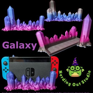 May include: A black Nintendo Switch console with blue and red controllers, displayed with decorative crystal formations in shades of purple and blue. The word "Galaxy" is displayed in purple text. The image also includes the logo for "Nerding Out Studio."