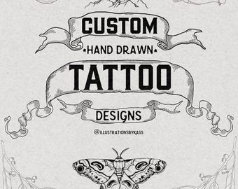 May include: Black and white illustration featuring the text "CUSTOM HAND DRAWN TATTOO DESIGNS". The design includes a moth, hands holding planets, mountains, and botanical elements. The artist's name is also included.