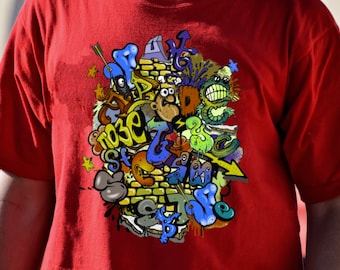 May include: Red t-shirt with a colorful graphic print of graffiti-style art featuring a brick wall, arrows, and cartoon characters. The text "Rose & Grace" is visible in the design.