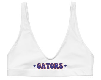 May include: White bikini top with a blue and orange "GATORS" graphic and two stars.