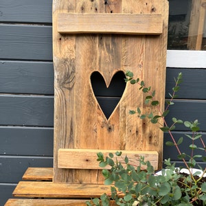 Country house window shutter with heart made of pallet wood for outside, rustic garden decoration