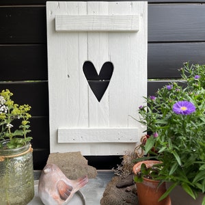 Country house window white shutter white with heart made of pallet wood for outdoors, rustic garden decoration in white